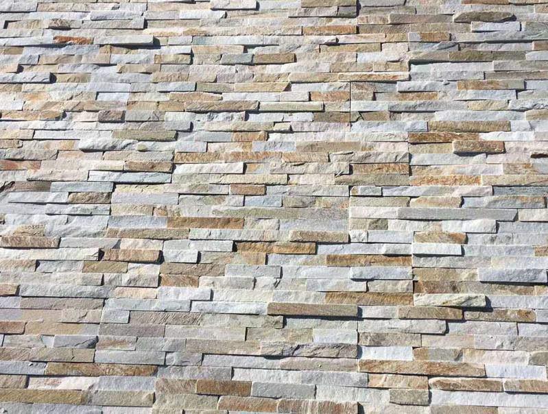 Durable natural stacked stone wall on exterior under sunlight, highlighting UV resistance
