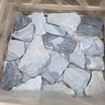 A collection of irregular flagstone pavers in various shapes and sizes for landscaping.