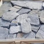 Collection of irregular flagstone pavers in various colors and textures