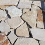 Collection of irregular flagstone pavers in varying colors and shapes