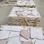 A variety of irregular flagstone pavers in different shapes and natural colors.