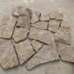 Diverse selection of irregular flagstone pavers in various colors and shapes