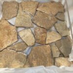 A collection of irregular flagstone pavers showcasing various textures and colors.