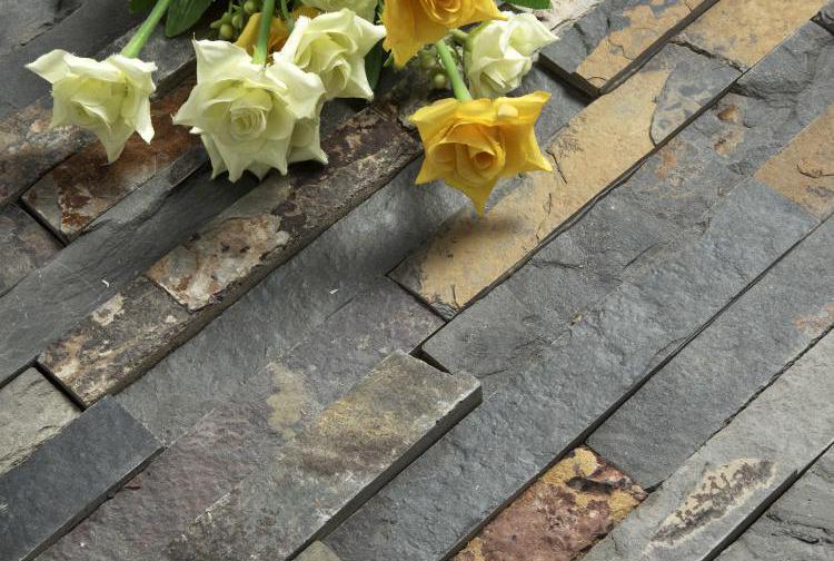 Side-by-side comparison of faux stone panels and real stone veneer