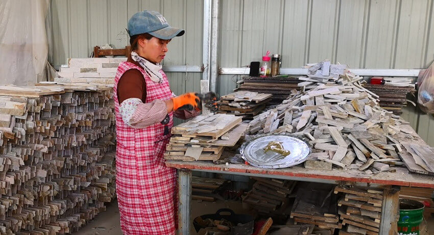 Workers engaged in the stacked stone production process