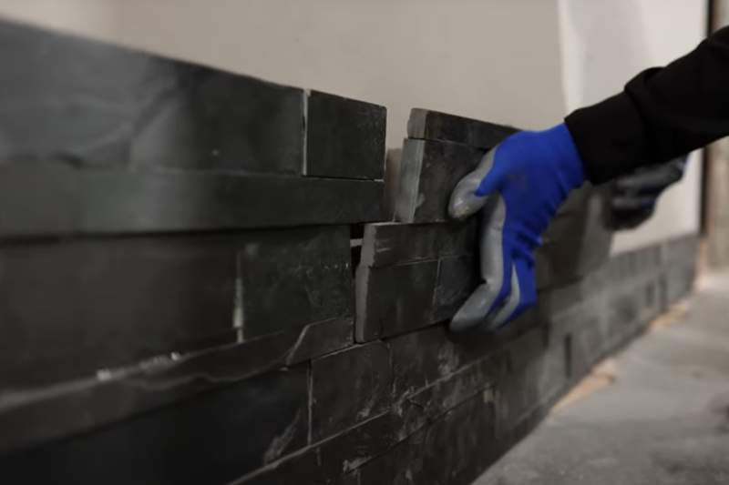 A professional installation of ledger stone cladding on an exterior wall