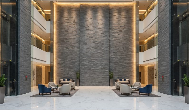 Modern stacked stone wall panels in a commercial lobby and retail space