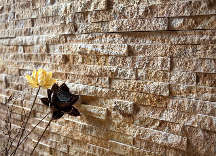Exterior wall finished with natural stacked stone cladding in layered stone panels