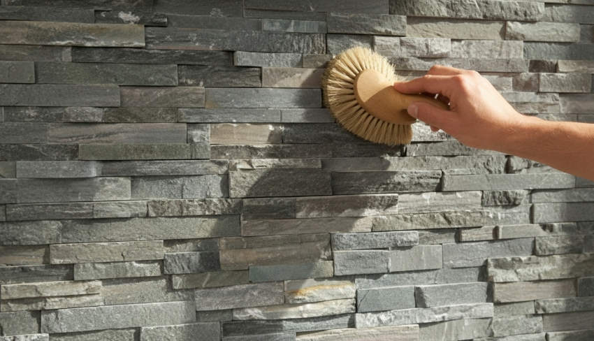 Modern outdoor fireplace with stacked stone veneer and natural textures