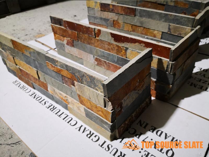 Golden-hued stacked slate stone corner piece for landscaping