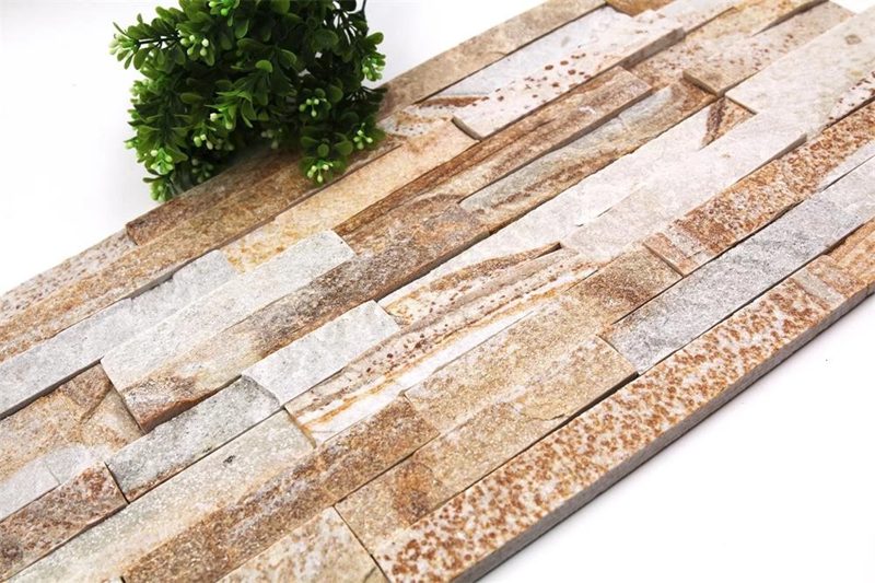 Elegant dining room featuring a textured stacked stone accent wall in neutral tones