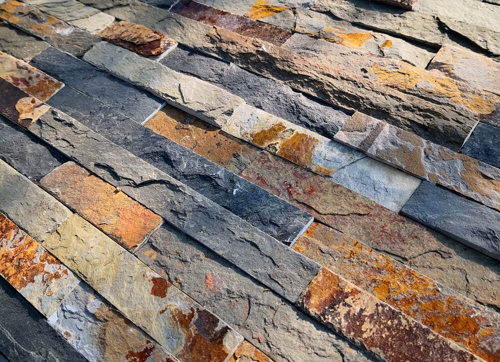 Rusty slate stacked stone wall panel with natural texture for interior or exterior cladding