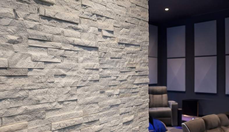Stacked stone installation enhancing acoustics in a room