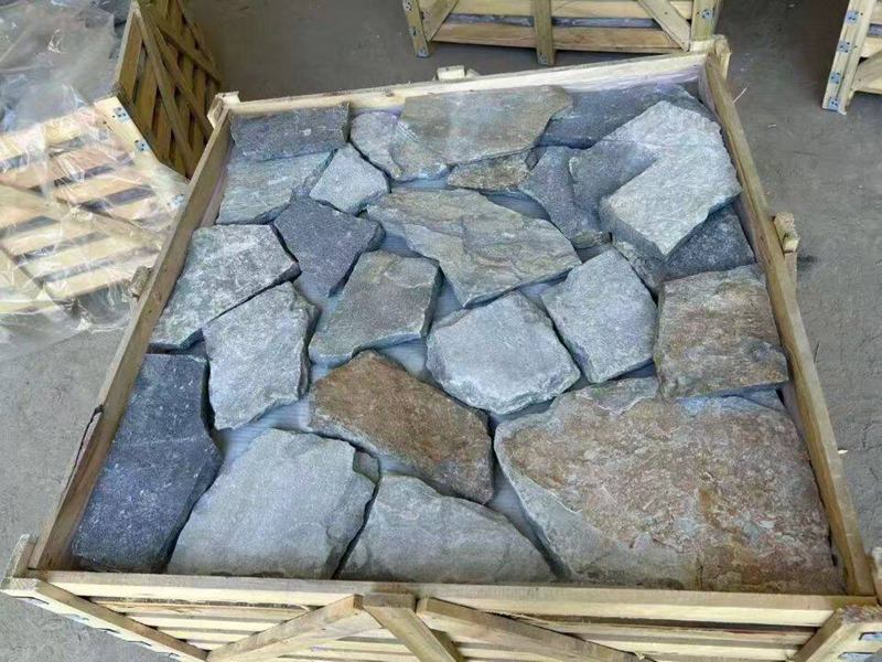 Collection of irregular flagstone pavers in various shapes and colors