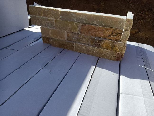 Beautiful corner installation of stacked stone panels in a natural setting