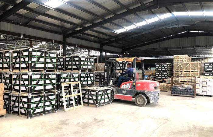 Interior view of CHUNYU Slate's stacked stone warehouse showcasing various stone panels.