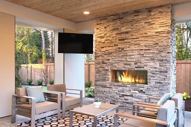 Modern stacked stone fireplace with warm ambiance