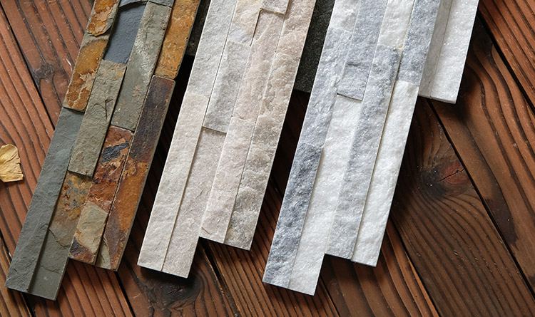 A close-up view of natural stone ledger panels in a stacked formation, perfect for wall cladding.
