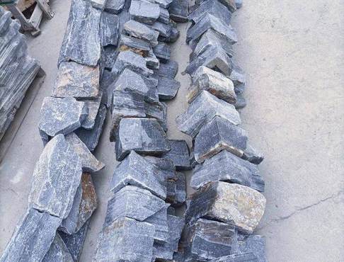 A close-up view of a textured stacked stone panel in natural colors
