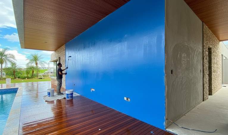 Hand preparing a wall surface for installing Z-shape stacked stone panels