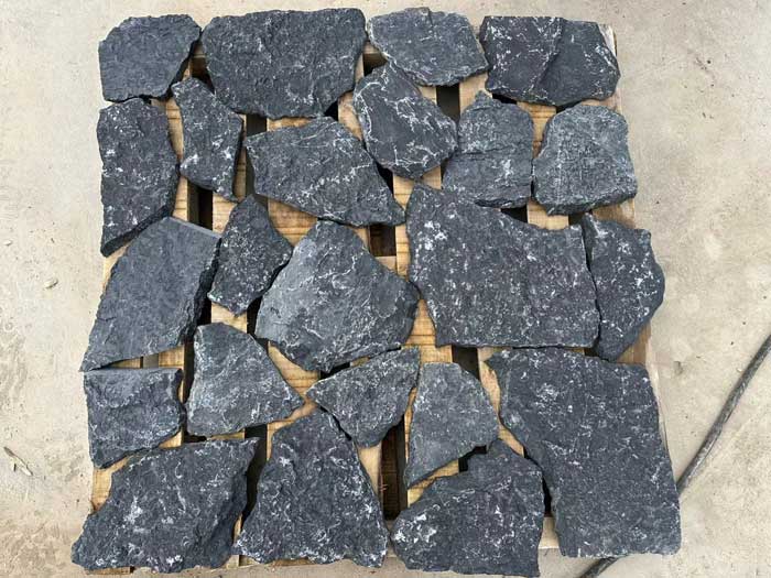 A vibrant display of free form natural loose stone wall cladding in earthy tones.